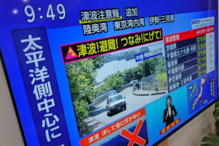 A-tsunami-warning-is-displayed-on-a-television-in-Yokohama Tsunami alerts for US, Japan, Philippines after massive Russia earthquake