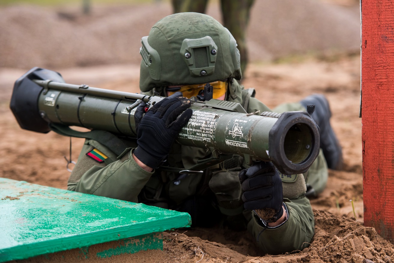 Soldier aiming AT4 rocket launcher during field exercise
